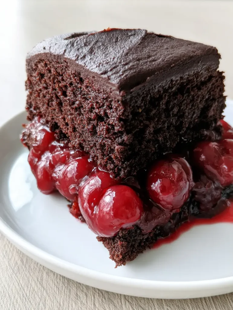 Close up of the whole pitted cherries inside the Chocolate Cake with Cherry Pie Filling layers.