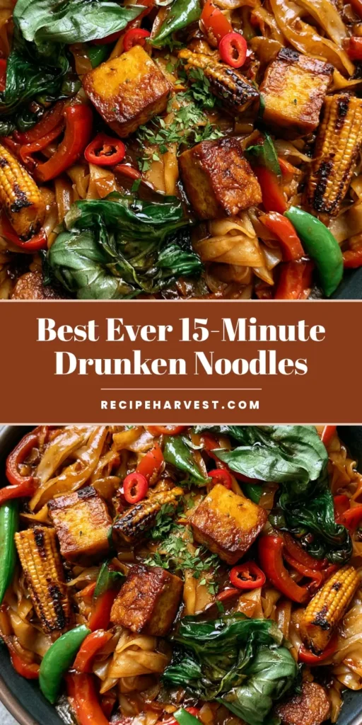 A close-up of Vegetarian Drunken Noodles in a dark bowl featuring wide rice noodles, seared tofu, red bell peppers, and fresh Thai basil.