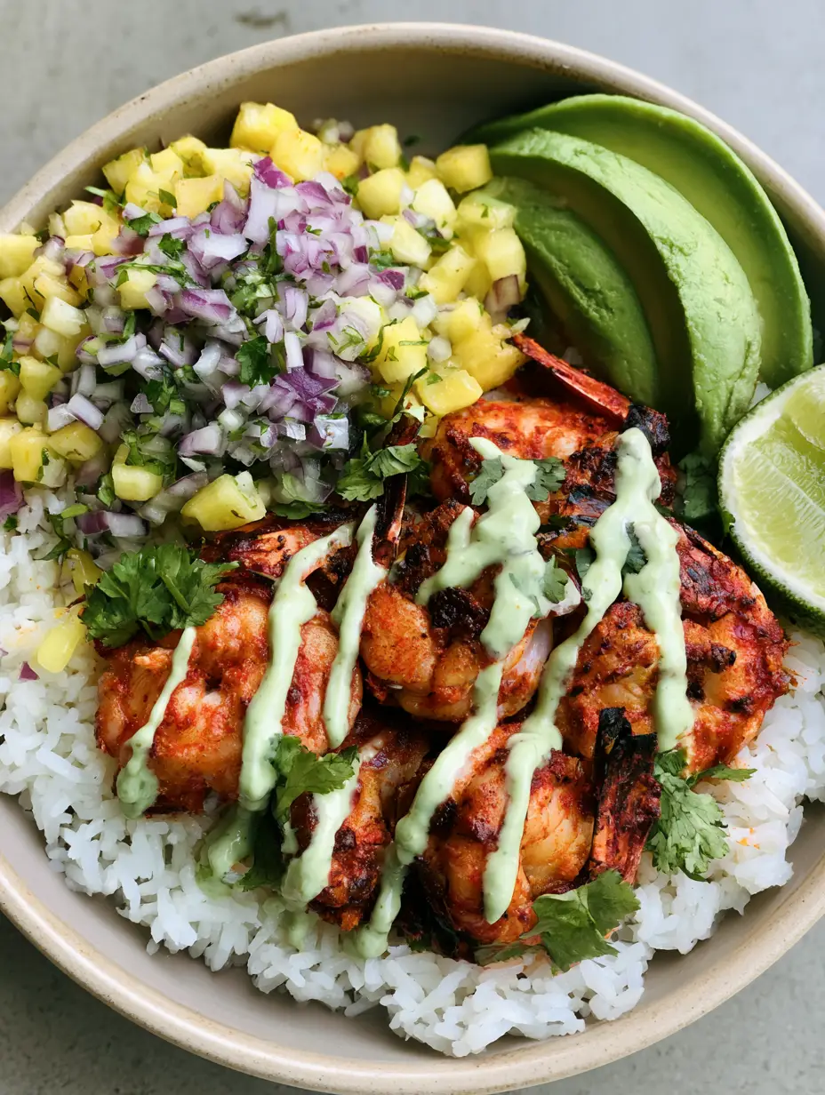 Close up view of charred shrimp with reddish-orange spice rub in a Shrimp Rice Bowl.