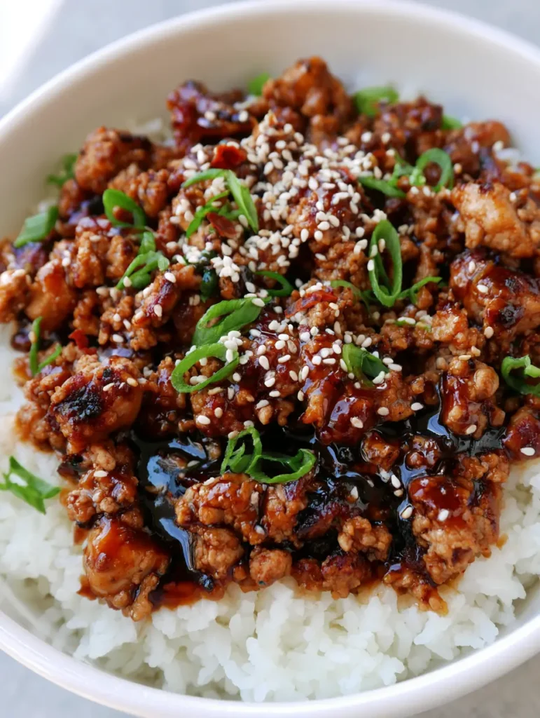 Honey Garlic Ground Turkey: The Ultimate 15-Minute Sticky Glazed Dinner 1 High angle shot of a white ceramic bowl filled with fluffy rice and Honey Garlic Ground Turkey.