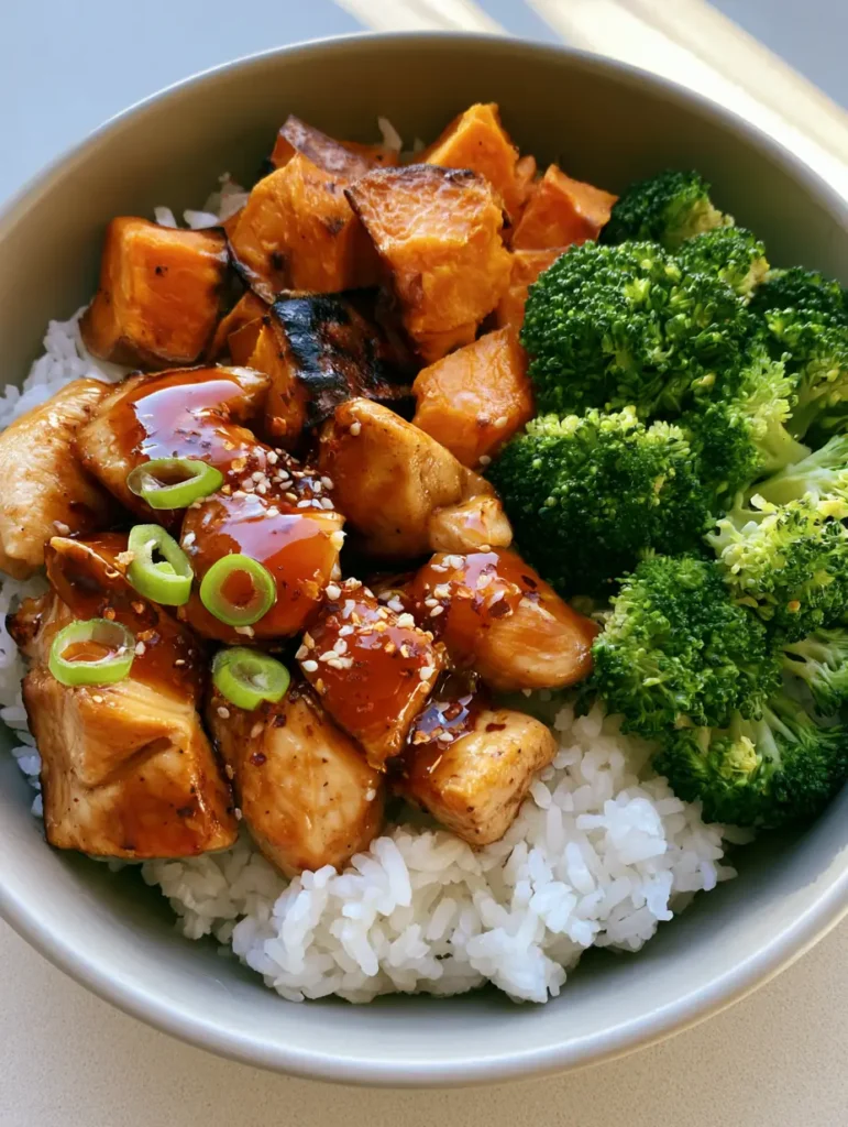 Hot Honey Chicken Bowls with Roasted Sweet Potatoes and Broccoli 1 Healthy dinner bowl with jasmine rice, hot honey chicken, charred sweet potatoes, and broccoli. (Hot Honey Chicken Bowls)