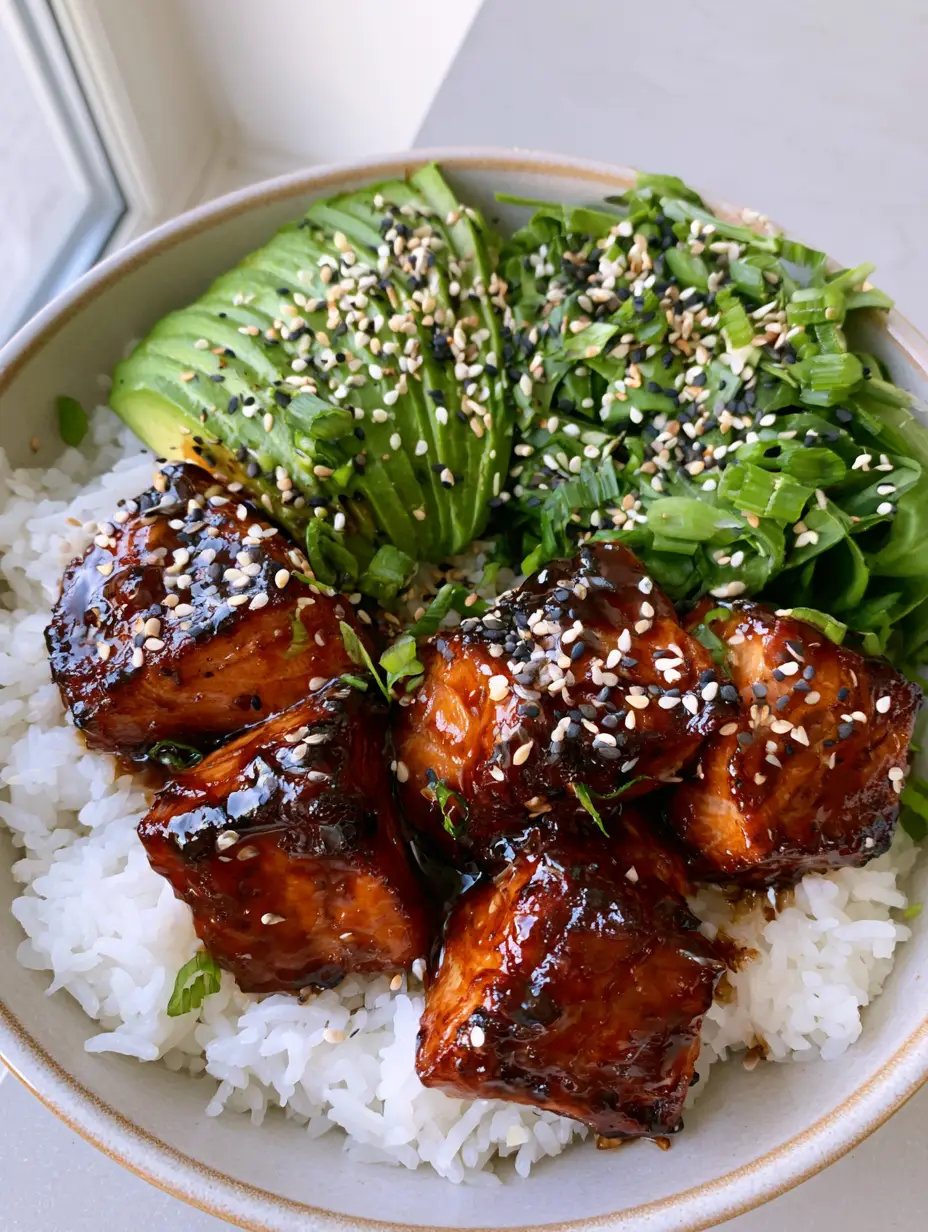 Teriyaki Salmon Bowl: The Ultimate 20-Minute Glossy Glazed Dinner 4 Close up of pan-seared salmon chunks in a Teriyaki Salmon Bowl with caramelized edges and toasted sesame seeds.