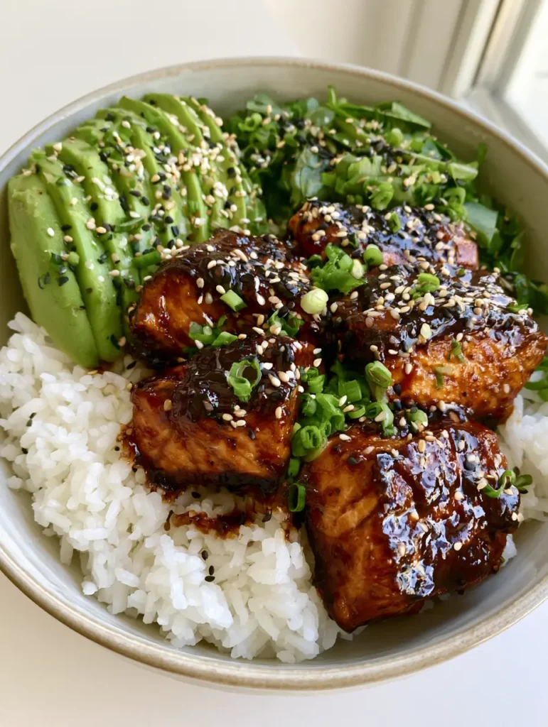 Teriyaki Salmon Bowl: The Ultimate 20-Minute Glossy Glazed Dinner 1 Teriyaki Salmon Bowl assembled with fresh mixed greens, sliced avocado, and scallions in a minimalist bowl.
